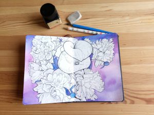 Sketchbook with a drawing of white peonies and zantedeschia flowers.