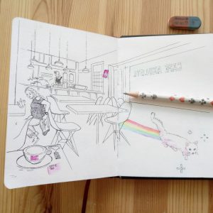 A sketchbook with a drawing of a cappucinobar with a barista, table, chairs and a woman moving her chair for a cat that crosses the bar, leaving rainbowcolored stripes and stars shaped like an anmimation from a digital game. The sign on the text on the window reads cafe axolotl